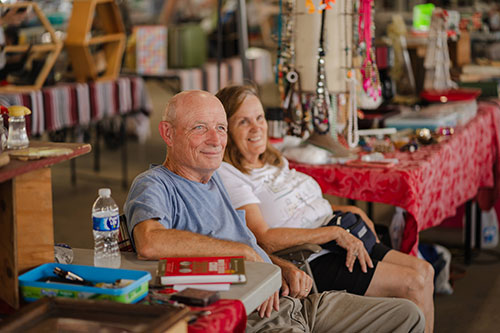 Flea Market customers sitting in chairs enjoying a break